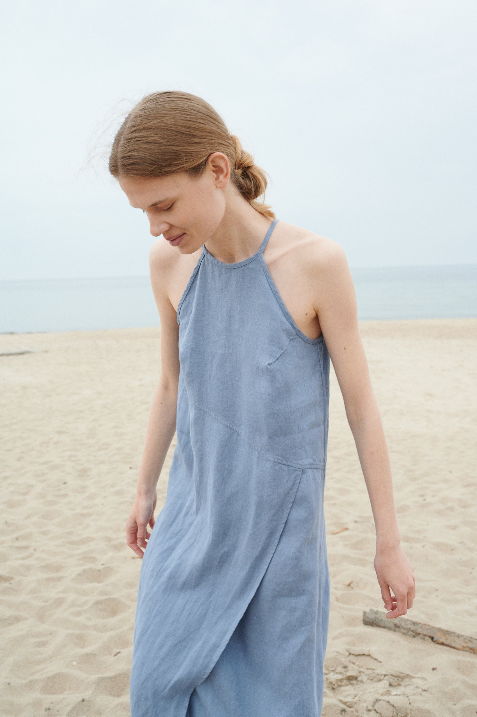 A muted blue linen summer dress with a halter neck