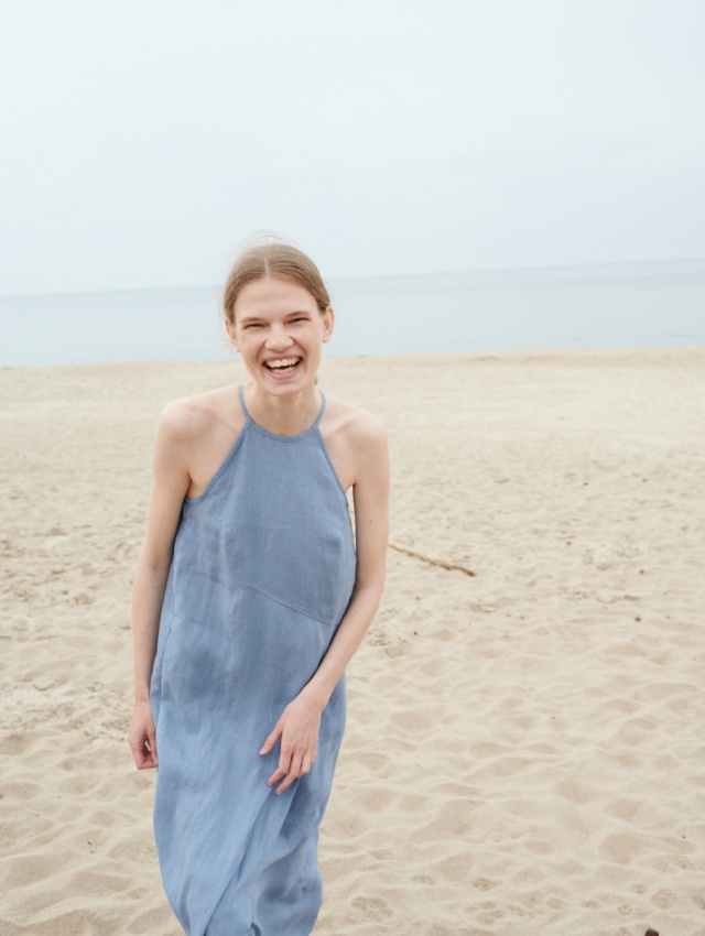 A sleeveless halter neck summer dress with an asymmetrical seam