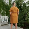 back of a woman in natural linen yellow dress