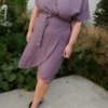 Woman wearing a wrap dress in purple linen