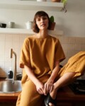 Model in loose-fitting linen trousers and an oversized linen top outfit