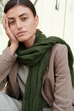 Model with heavy linen jacket and green scarf