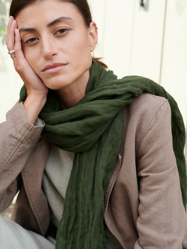 Model with heavy linen jacket and green scarf