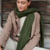 Forest green linen scarf wrapped around the neck