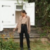An unbuttoned loose-fitting brown linen shirt paired with black linen pants