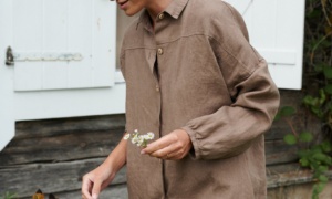 A model wearing a brown oversized linen shirt