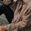 Ruched sleeves of a brown linen button down