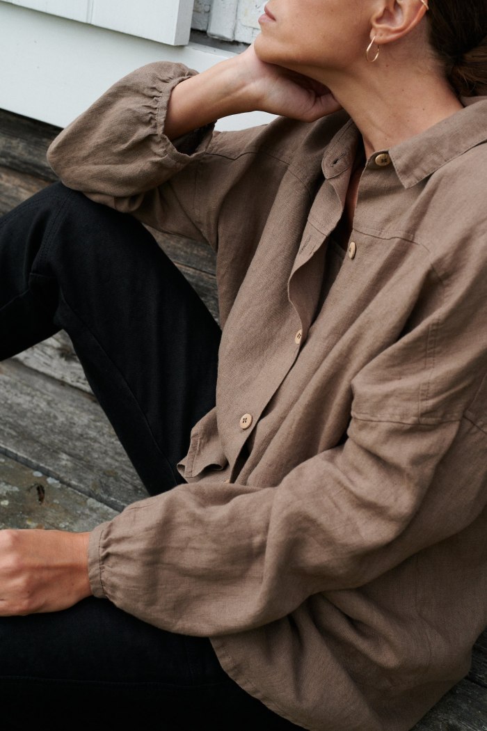 Ruched sleeves of a brown linen button down