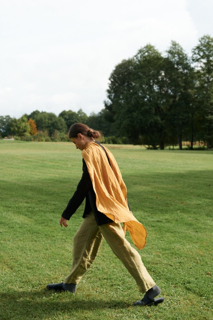Model with a mustard yellow flowing linen scarf