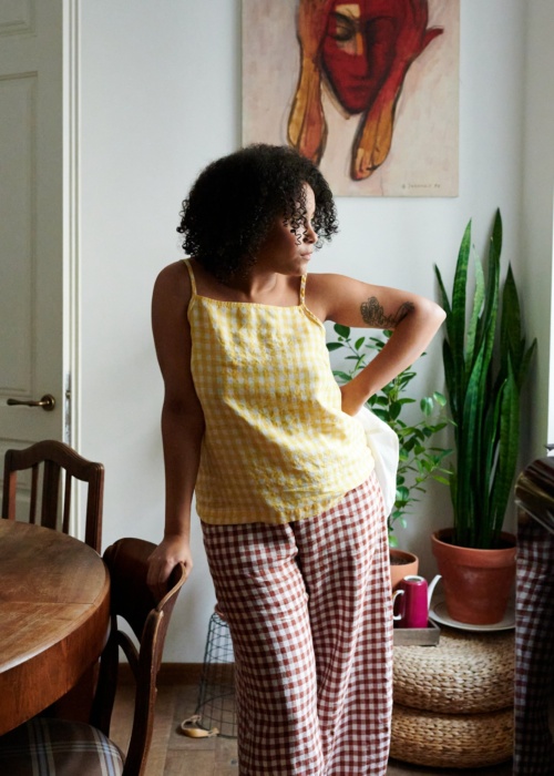 A yellow gingham linen sleeveless top paired with wide-leg terracotta linen pants