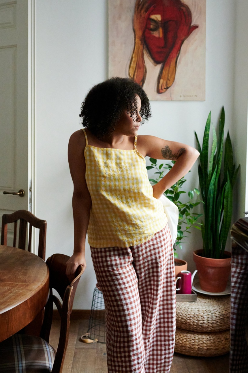 A yellow gingham linen sleeveless top paired with wide-leg terracotta linen pants