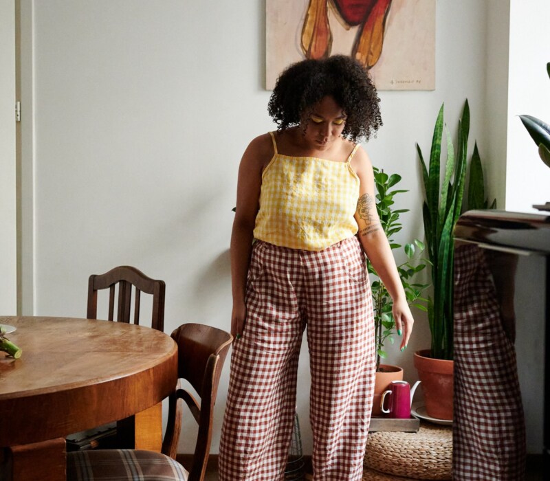 A model in brown gingham linen trousers