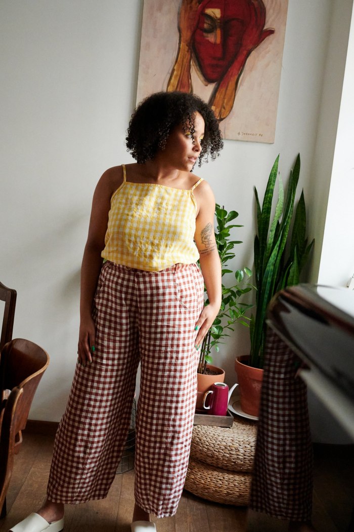 A woman in brown gingham linen trousers