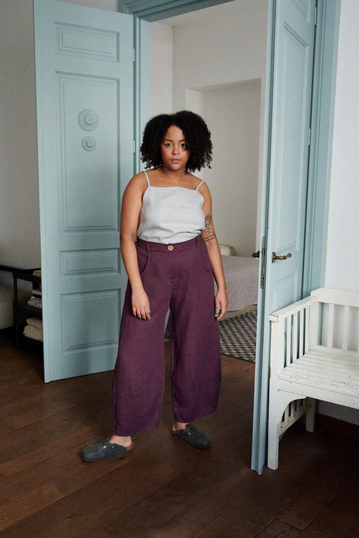 A model wearing purple linen barrel trousers