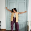 A woman in violet high waisted linen pants