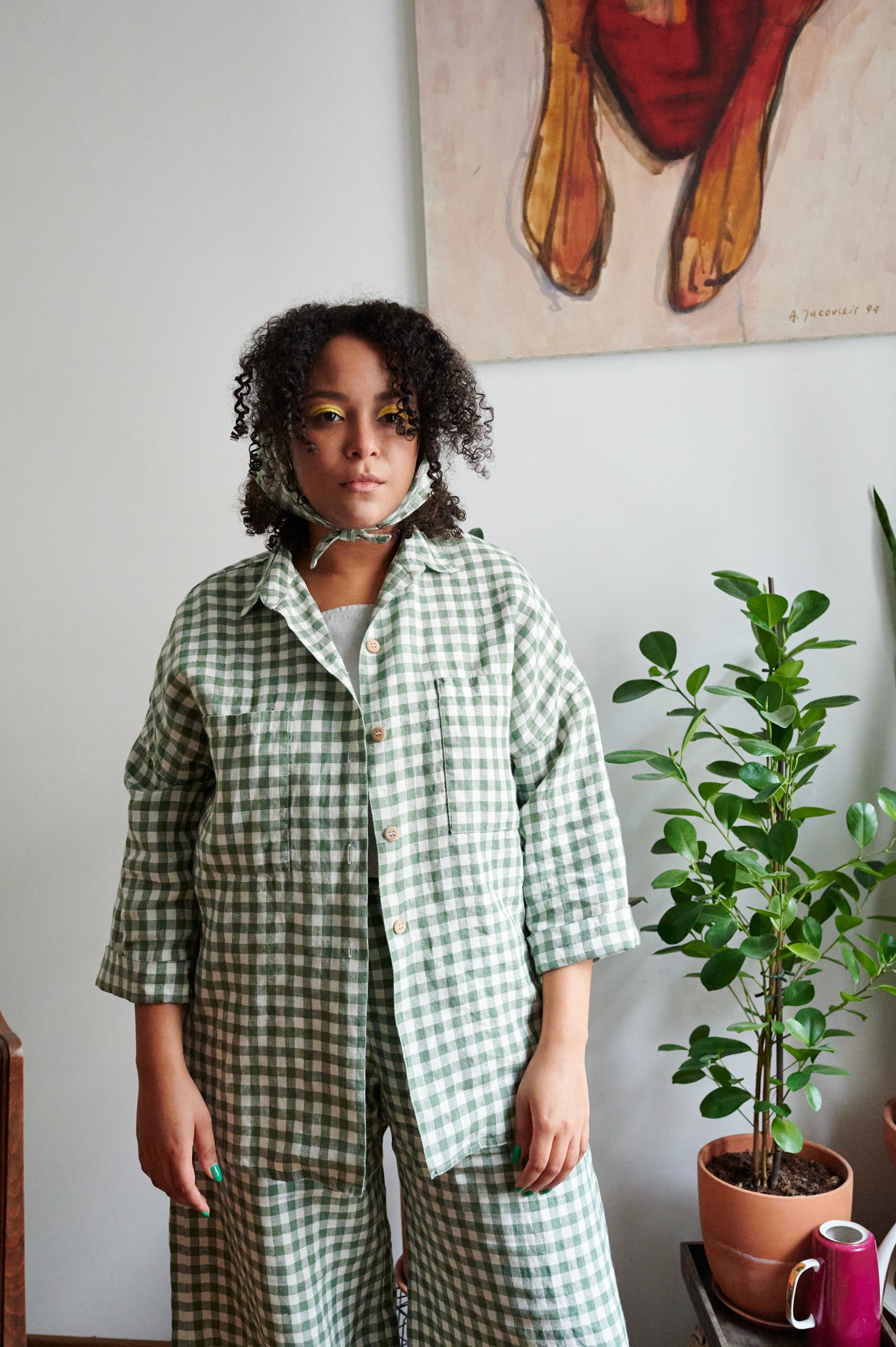 A model in green gingham oversized linen shirt