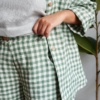 Elasticated waist of green gingham linen trousers