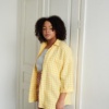 A yellow gingham pattern oversized linen shirt with three-quarter rolled up sleeves