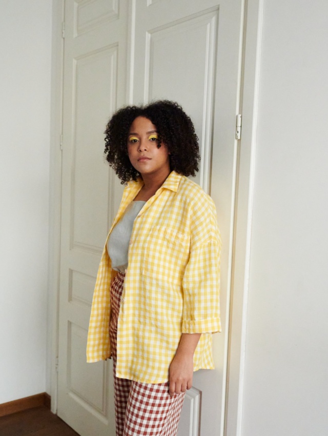 A yellow gingham pattern oversized linen shirt with three-quarter rolled up sleeves