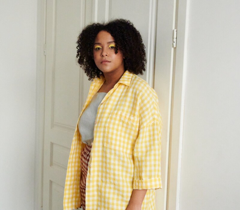 A yellow gingham pattern oversized linen shirt with three-quarter rolled up sleeves
