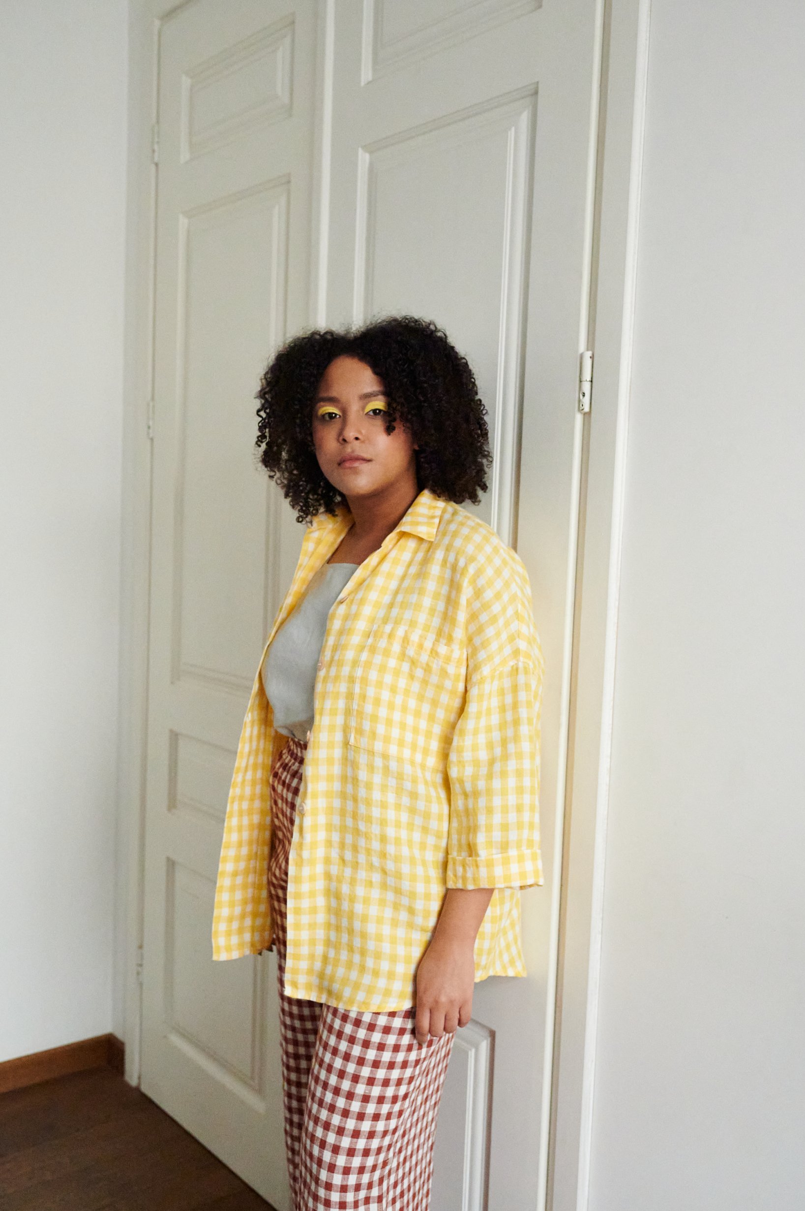 A yellow gingham pattern oversized linen shirt with three-quarter rolled up sleeves