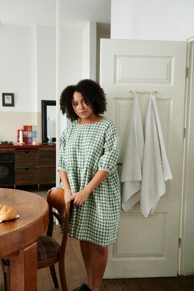 Women wearing green gingham dress at home