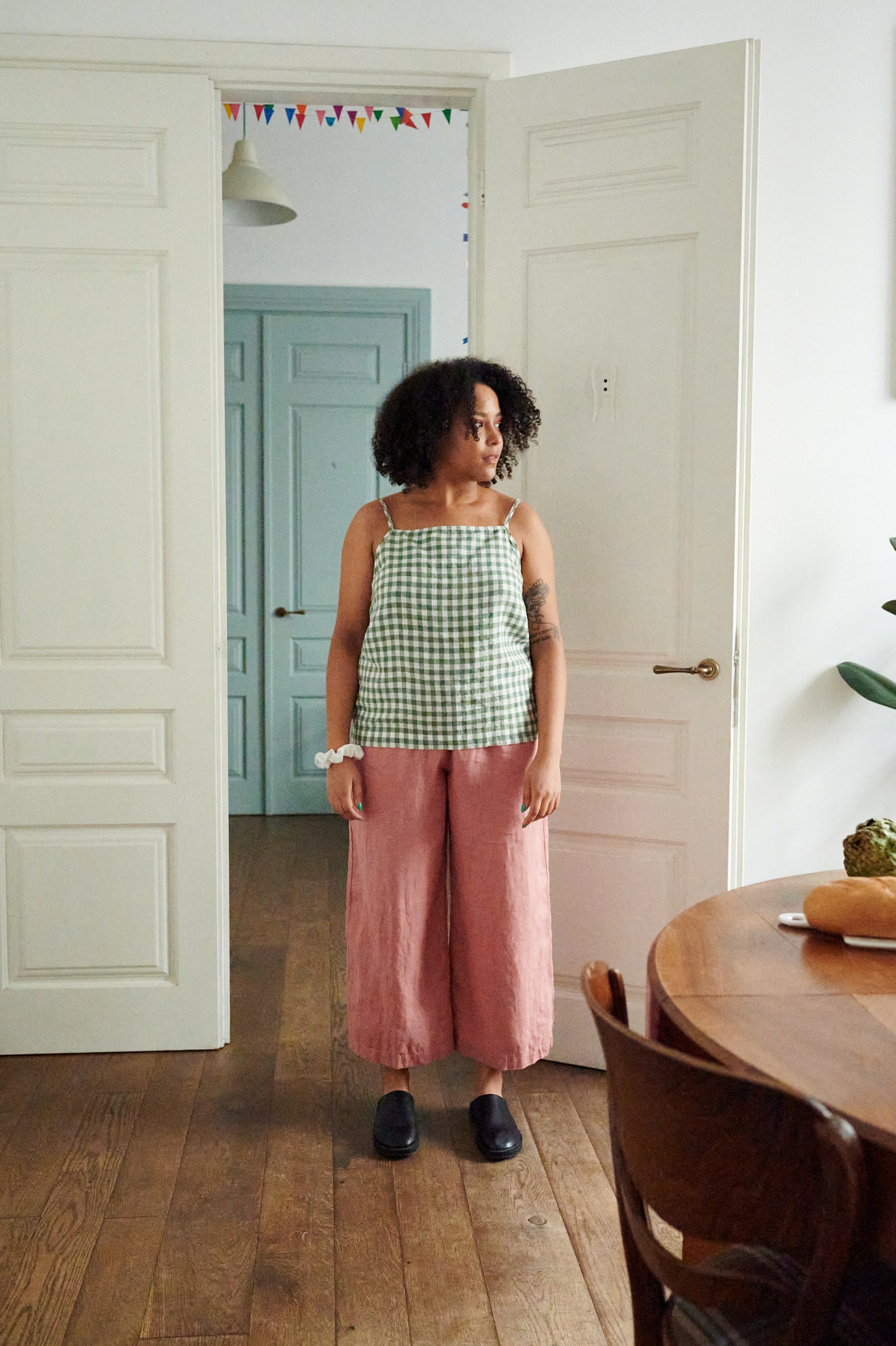 A green gingham linen summer top paired with red gingham wide-leg cropped linen pants