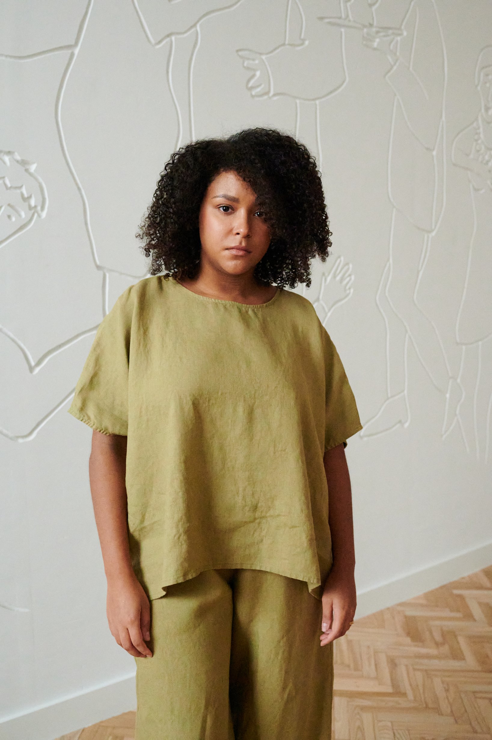 Model wearing linen top in olive
