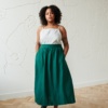 Linen emerald green midi skirt on a model