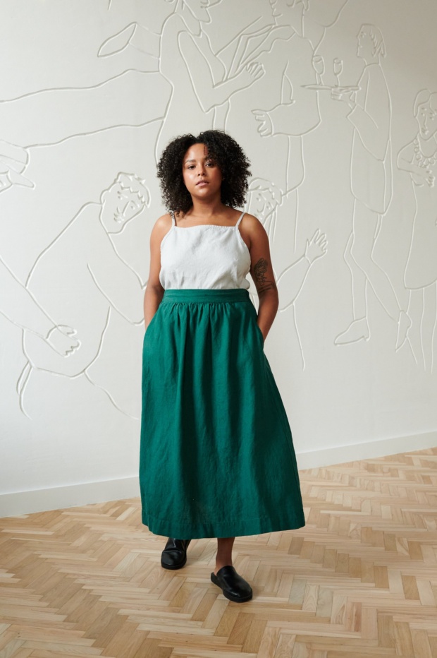 Linen emerald green midi skirt on a model