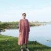 A woman in natural linen smock dress