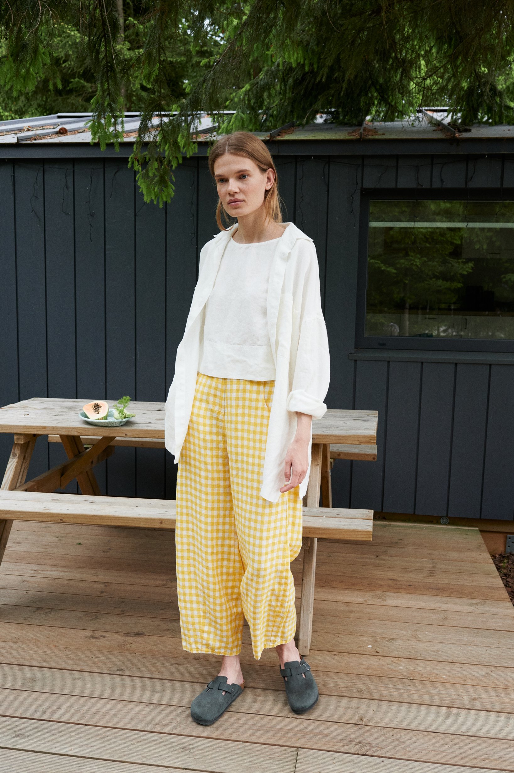 A model wearing summer linen trousers in yellow gingham