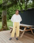 A woman in yellow gingham barrel leg linen trousers