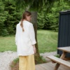 The back of natural linen barrel leg trousers in yellow gingham