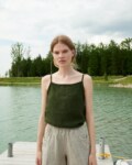 A dark green waffle linen summer top with thin straps and a high neckline