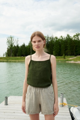 A dark green waffle linen summer top with thin straps and a high neckline