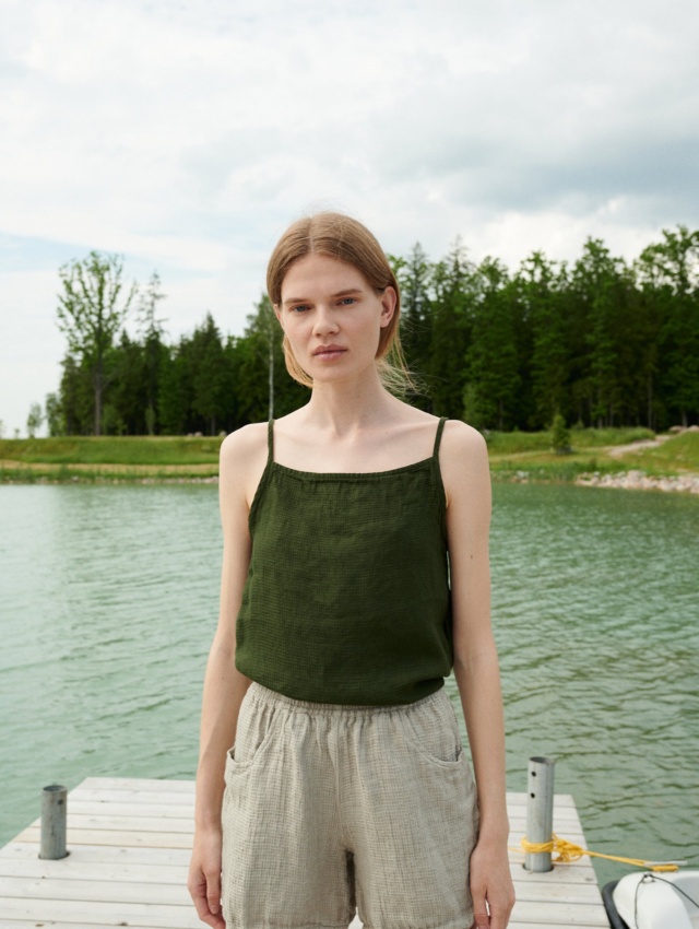 A dark green waffle linen summer top with thin straps and a high neckline