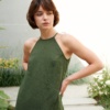 A forest green sleeveless linen dress with a halter neck