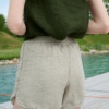 Close up of wide leg waffle linen shorts with an elasticated waistband and a curved hem