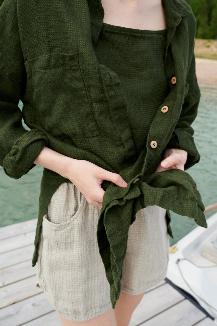 A loose fitting dark green waffle linen button down shirt with wooden buttons