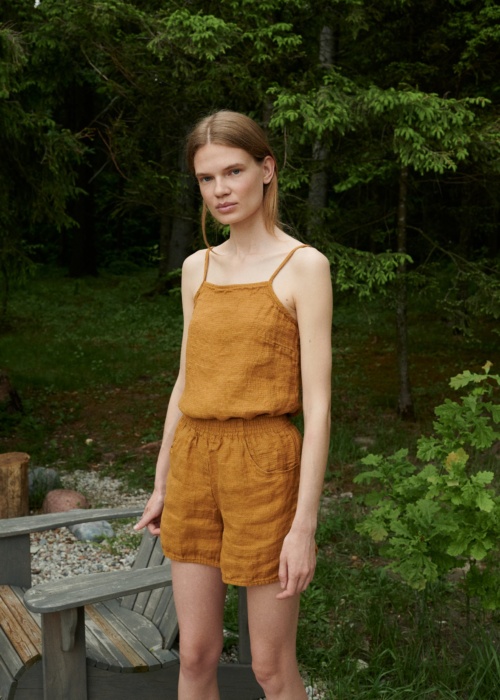 A waffle linen top with thin straps tucked into linen shorts