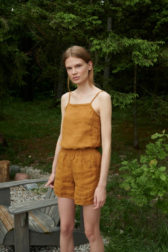 A waffle linen top with thin straps tucked into linen shorts