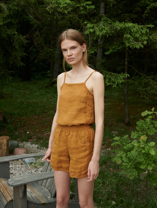 A waffle linen top with thin straps tucked into linen shorts