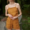 Woman wearing.a waffle linen summer top tucked into wide leg linen shorts
