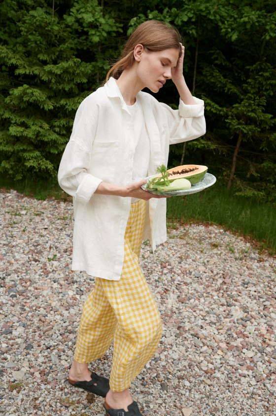A woman wearing white linen Linenfox shirt