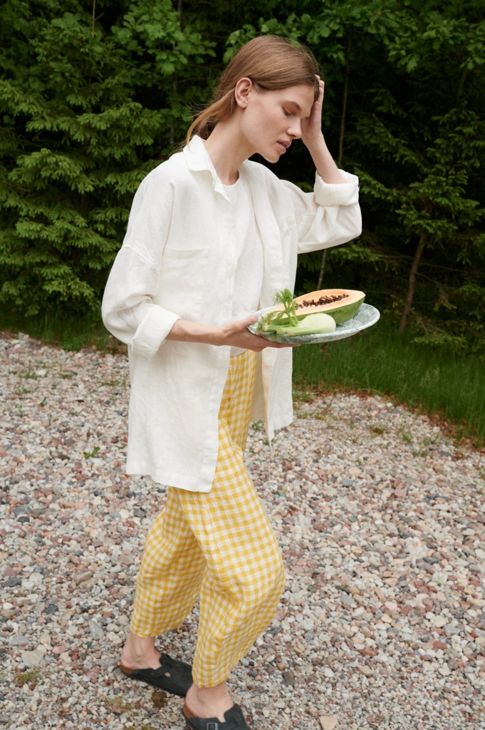 A woman wearing white linen Linenfox shirt