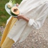 Woman in an oversized airy linen shirt and yellow gingham linen trousers outfit