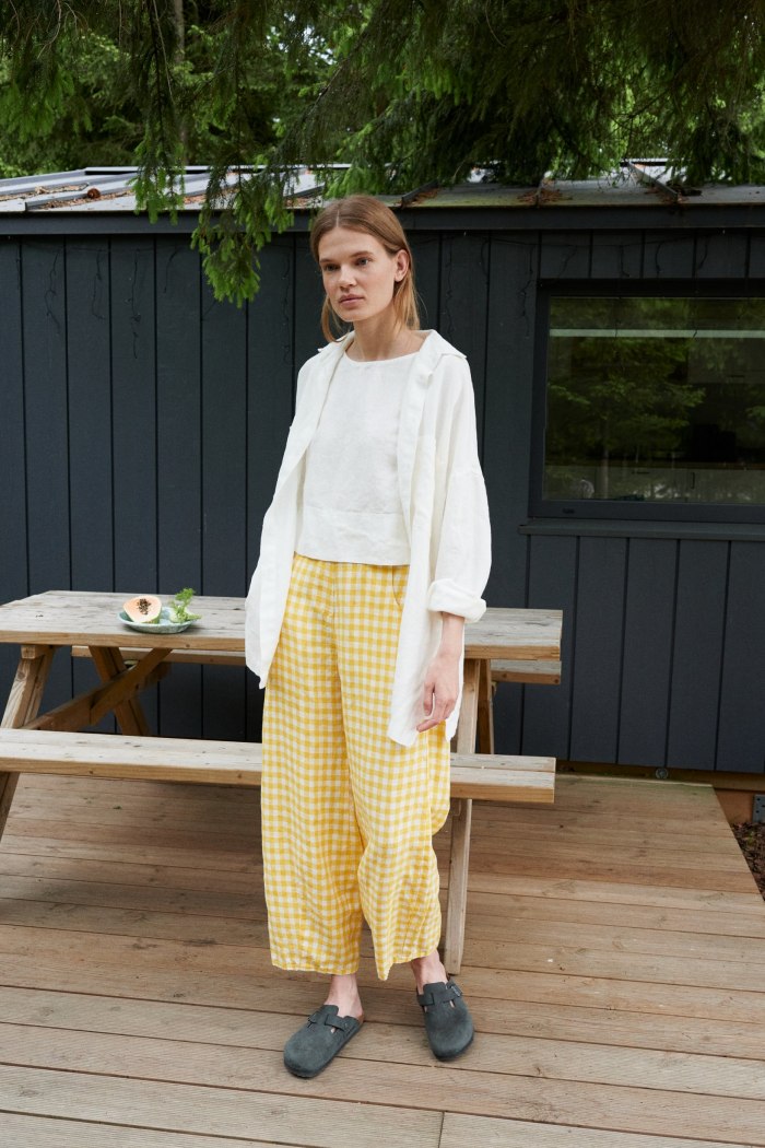 A woman in white linen button down