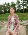 A model in brown gingham oversized linen shirt