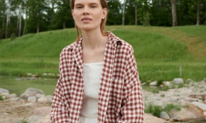 A model in brown gingham oversized linen shirt